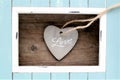 Light blue colored frame and stone heart with the word Love Royalty Free Stock Photo